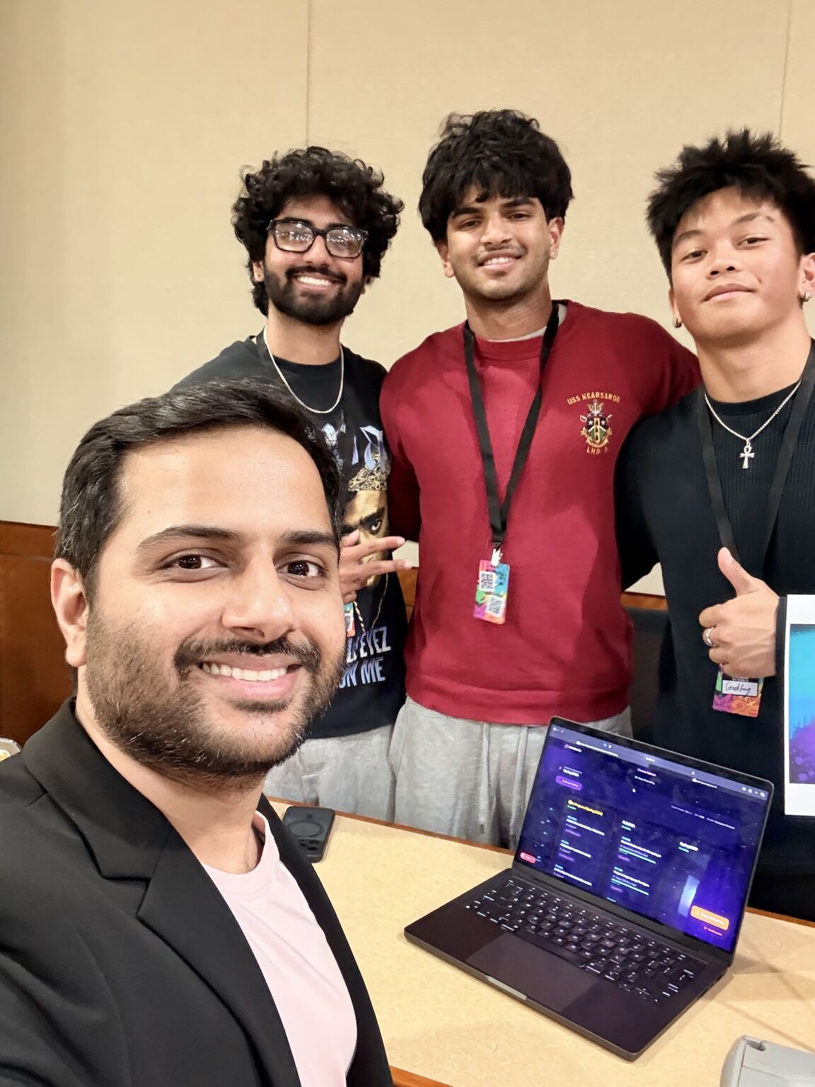 HackAI 2026 judge Abhishek Rai with the CometAdvisor team, the app open on a laptop
